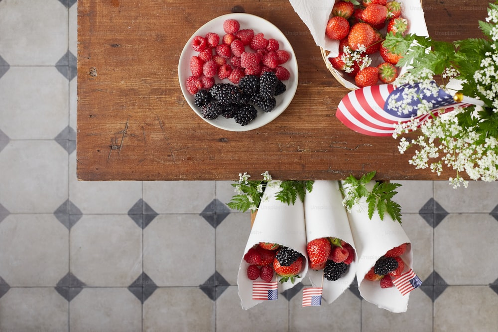 a wooden table topped with plates of fruit