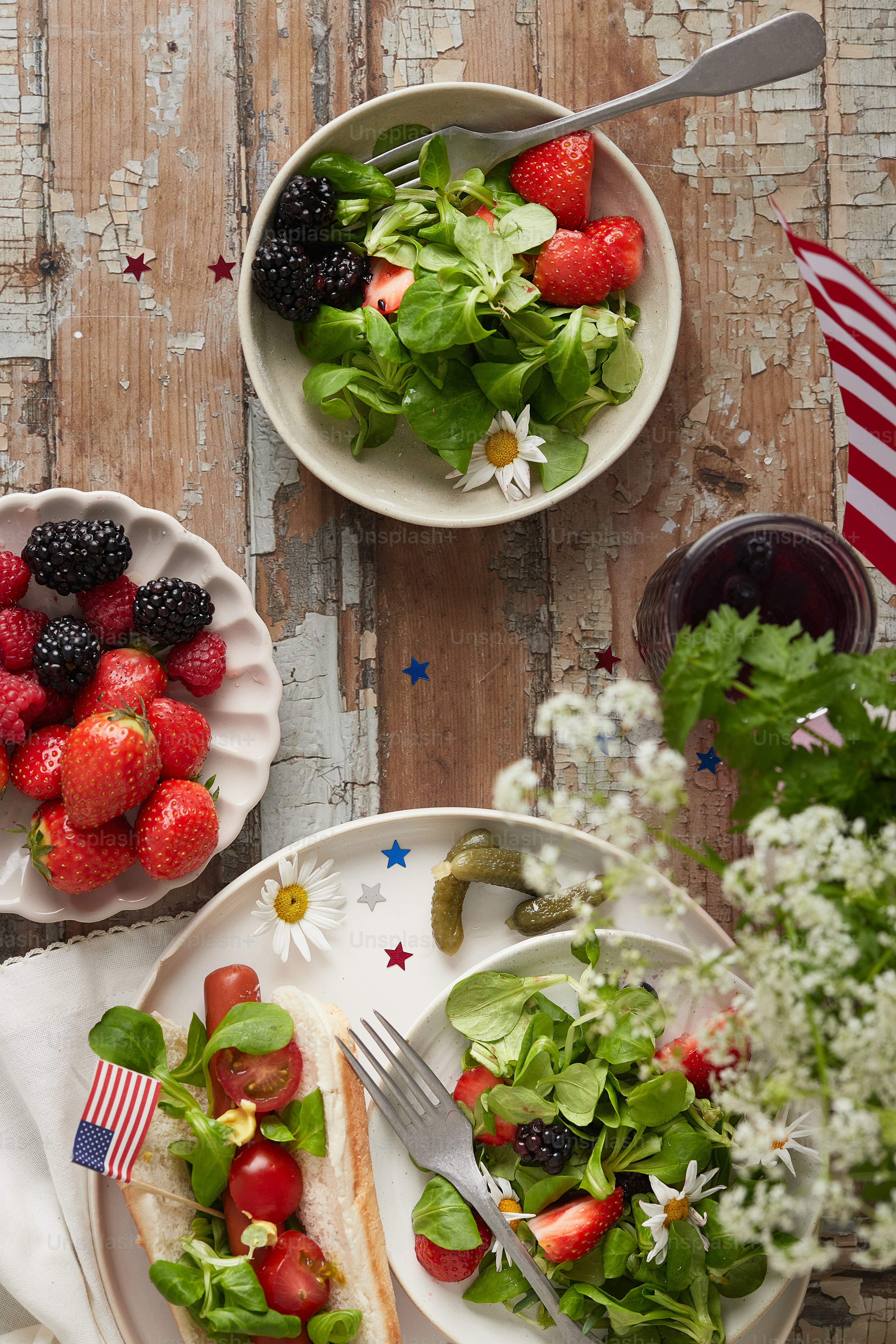 a table topped with plates of fruit and salad