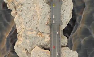 an aerial view of a road between two large rocks