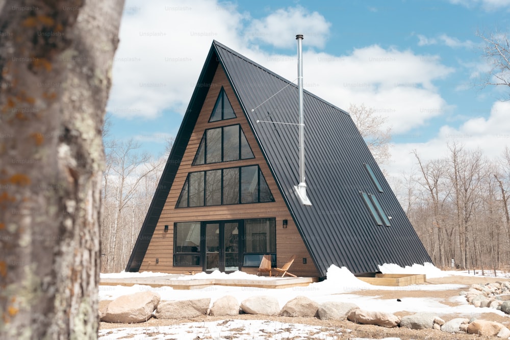 a small wooden cabin with a black roof