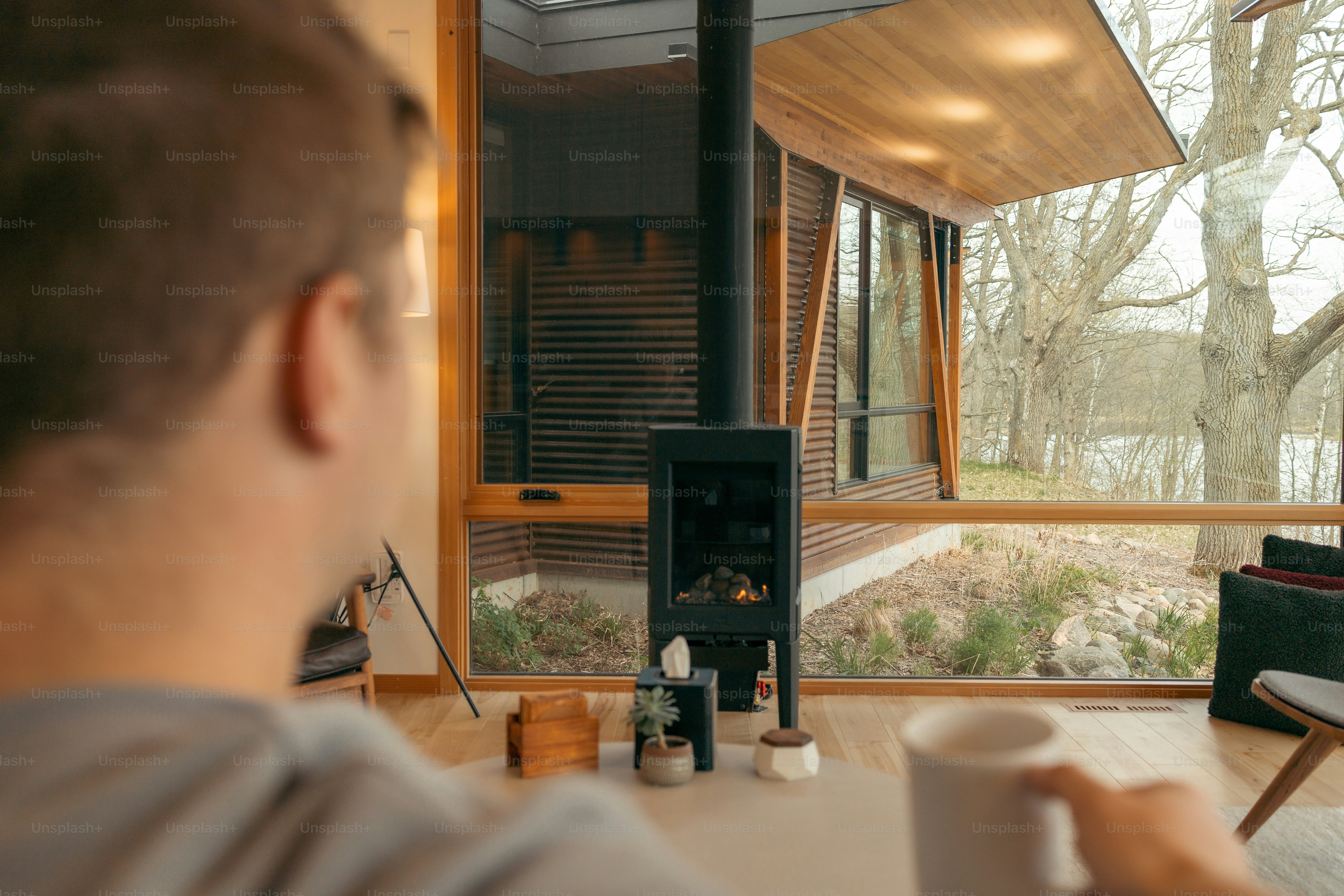 a man sitting at a table with a cup of coffee