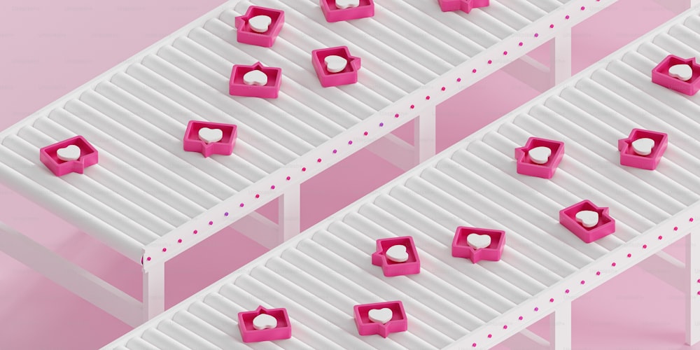 a group of pink cubes sitting on top of a white shelf