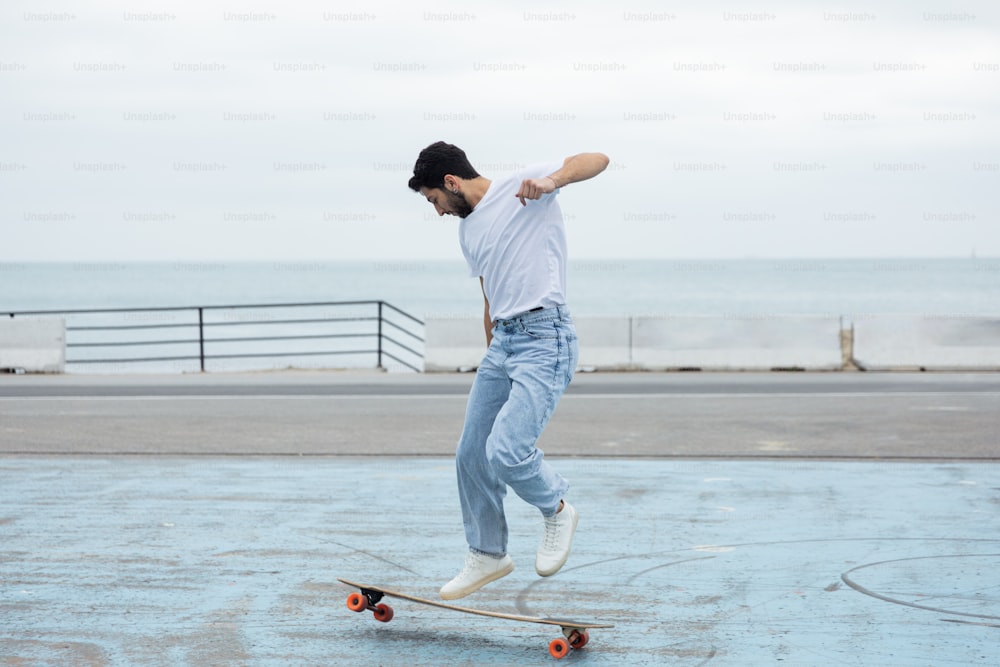 a man riding a skateboard on top of a parking lot