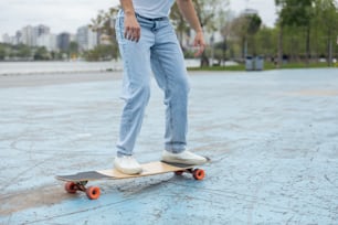 a man standing on a skateboard in a parking lot