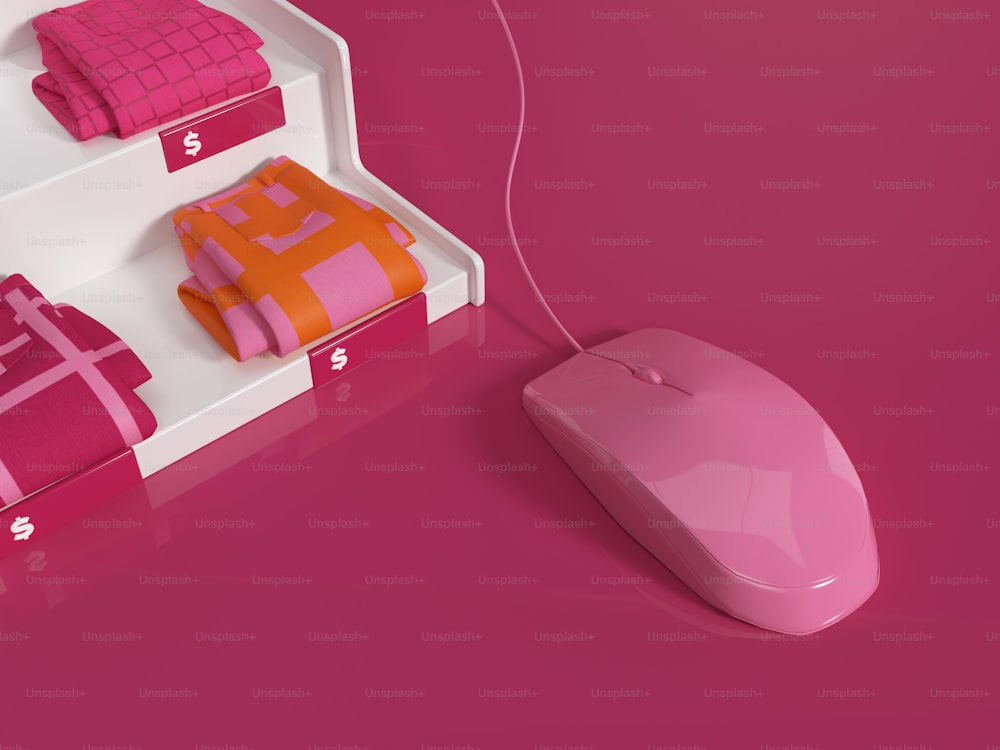 a computer mouse sitting on top of a pink surface
