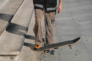 a person standing on a skateboard on a sidewalk