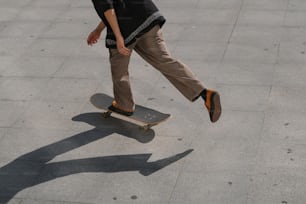 a man riding a skateboard down a sidewalk