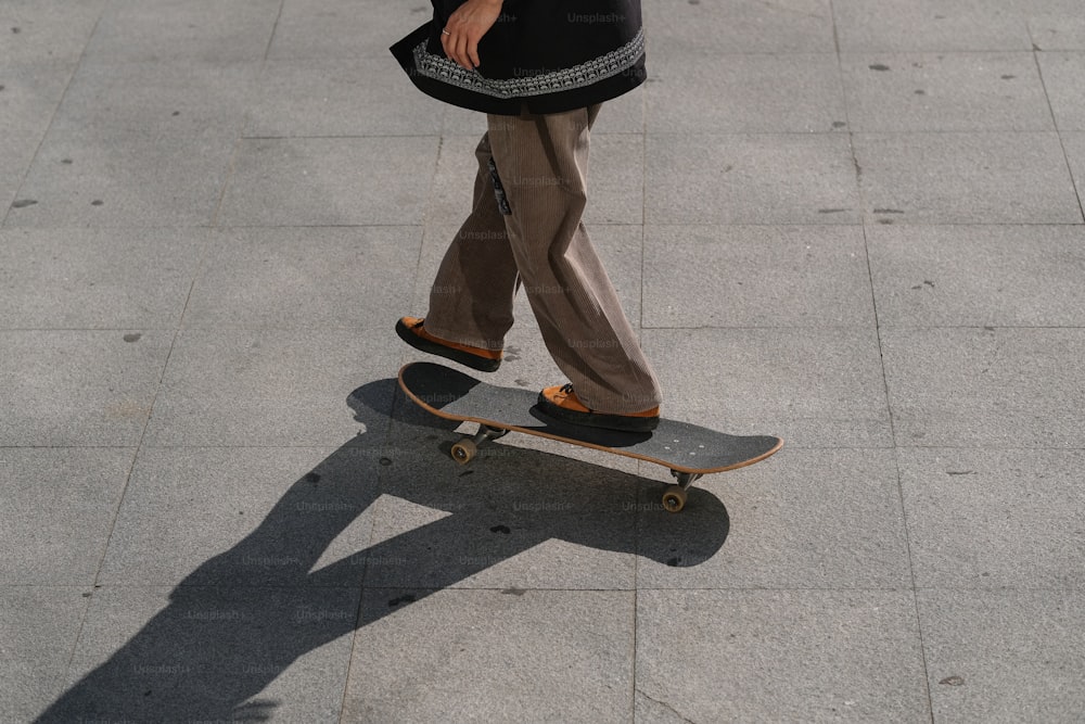 a man riding a skateboard down a sidewalk