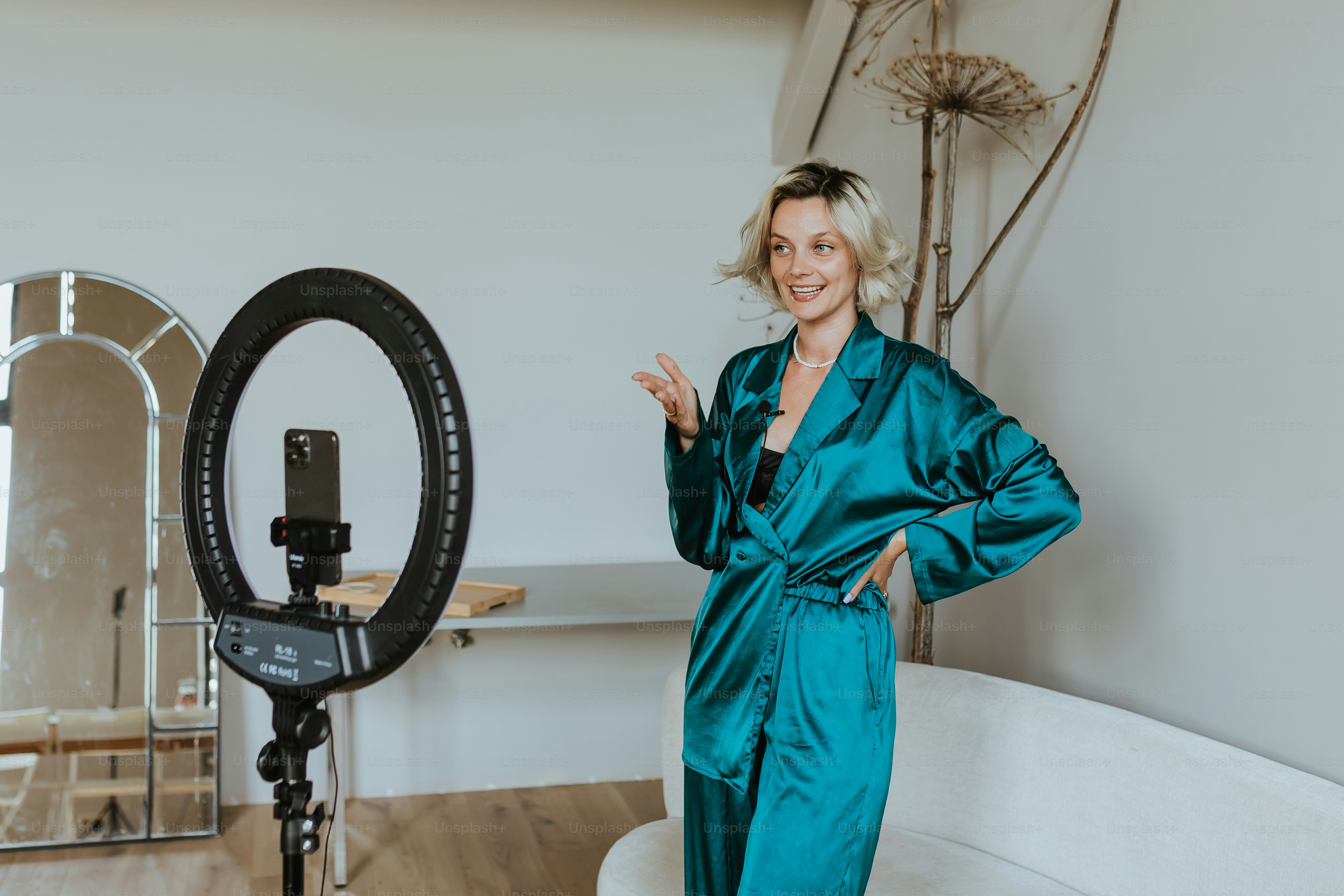 A woman in a blue robe standing in front of a camera photo – Content ...