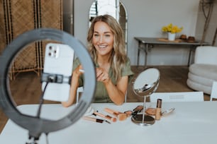 a woman sitting at a table in front of a mirror