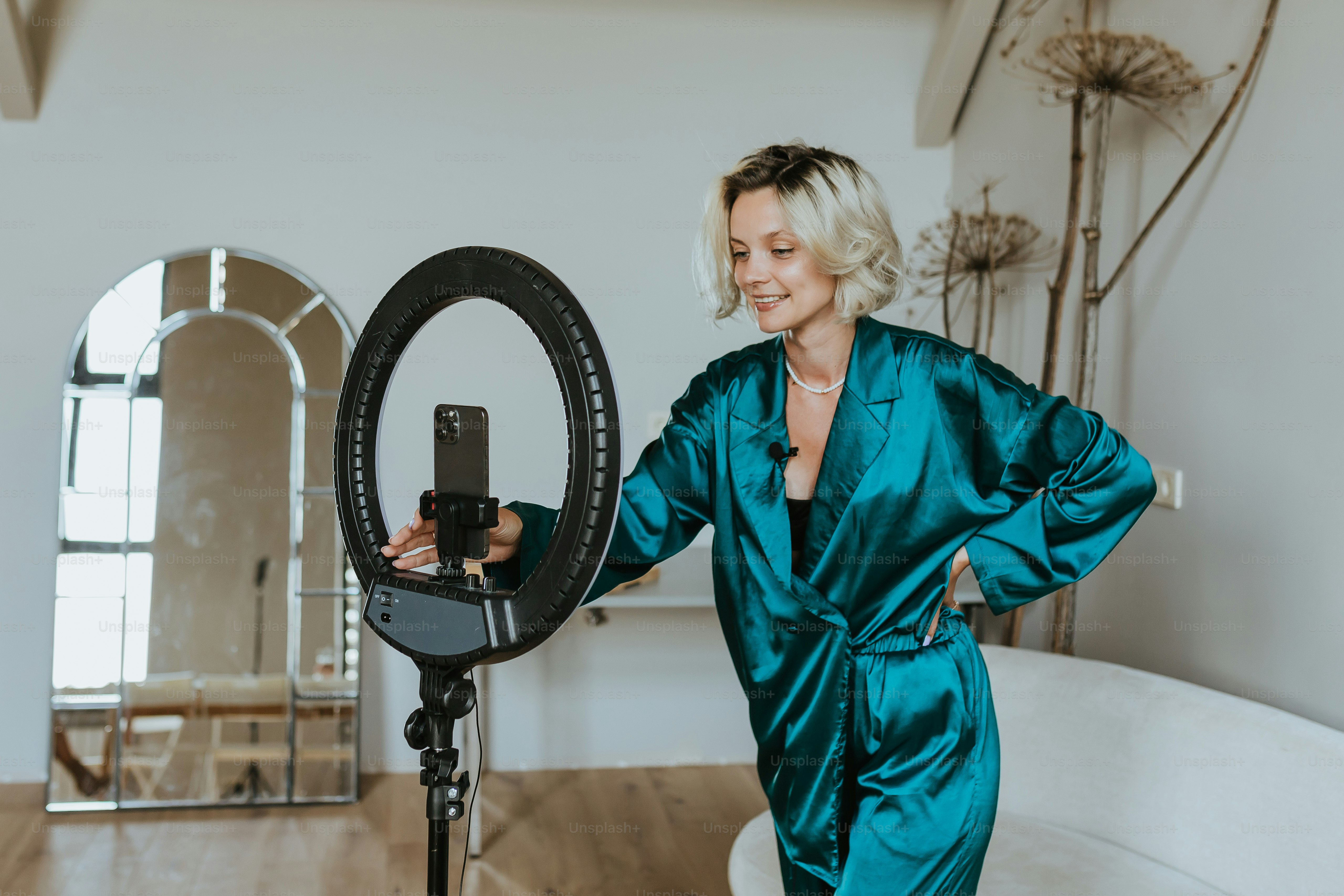 a woman in a blue robe is holding a camera