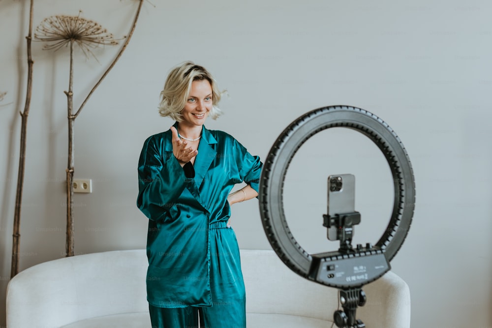 a woman standing in front of a camera