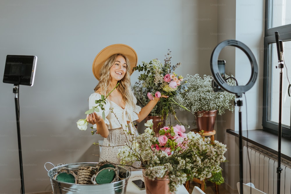 a woman standing next to a bunch of flowers