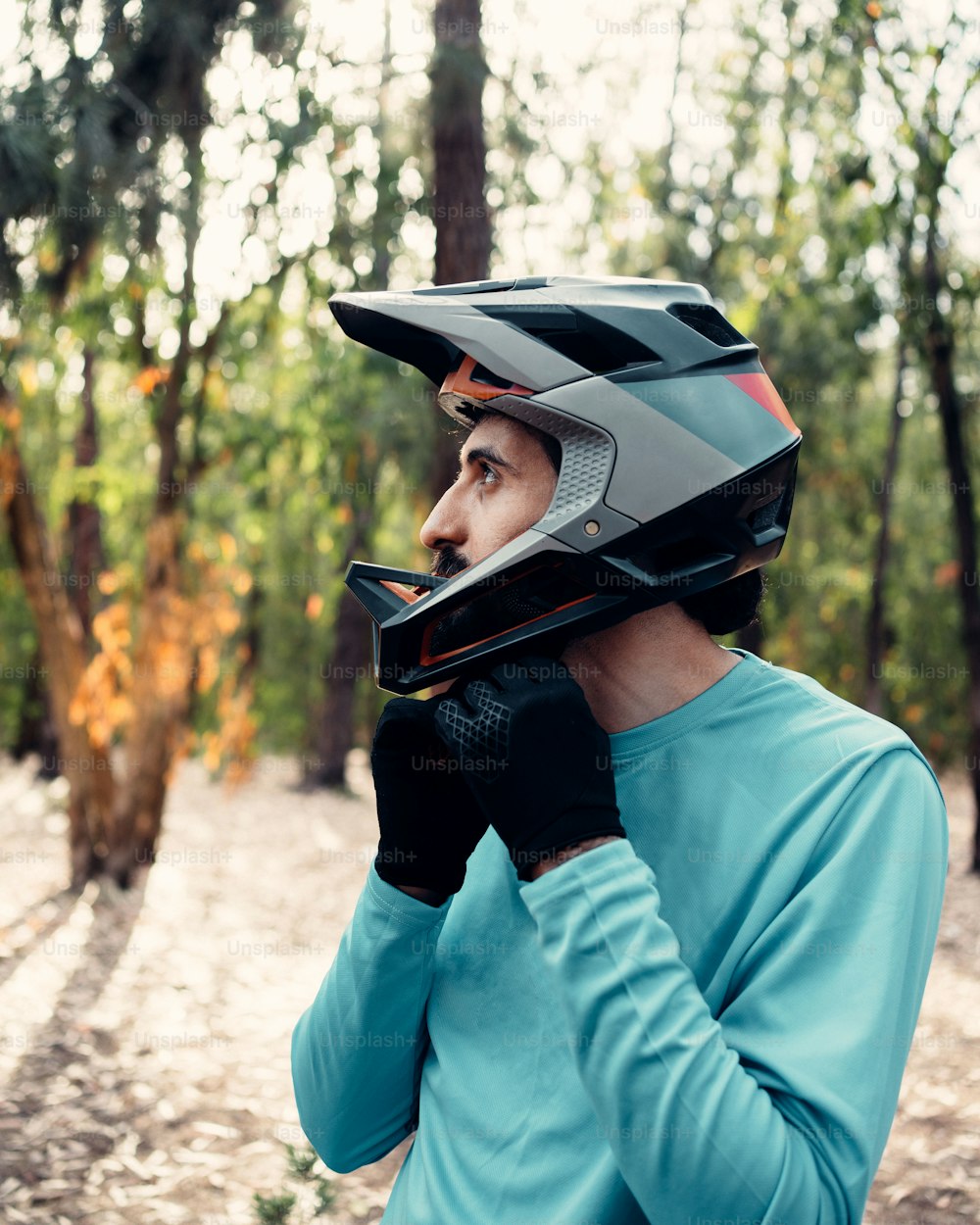 a man wearing a helmet while talking on a cell phone