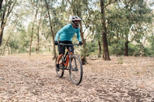 a man riding a bike through a forest