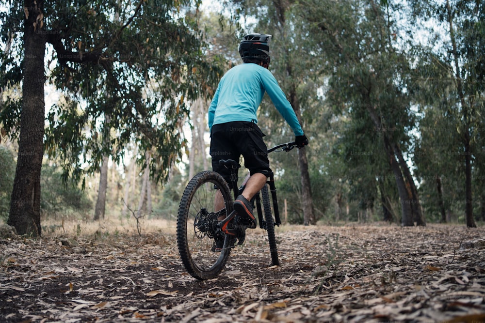 a person riding a bike through a forest