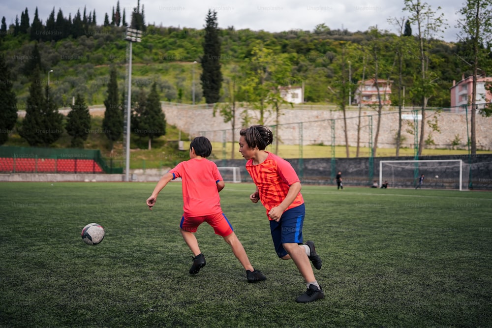 a couple of kids playing a game of soccer