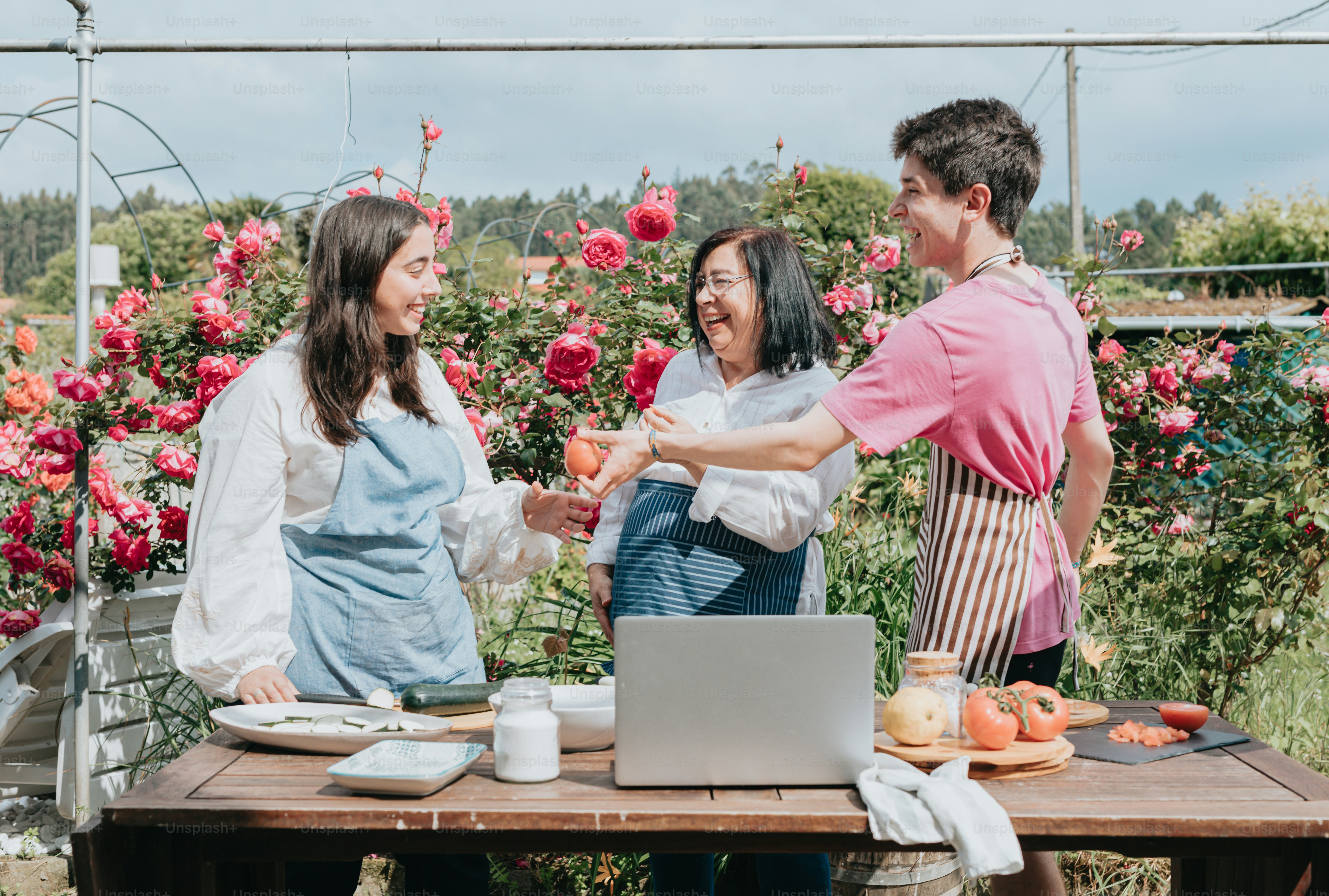 um grupo de pessoas em pé ao redor de uma mesa com um laptop