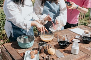 a group of people standing around a wooden table