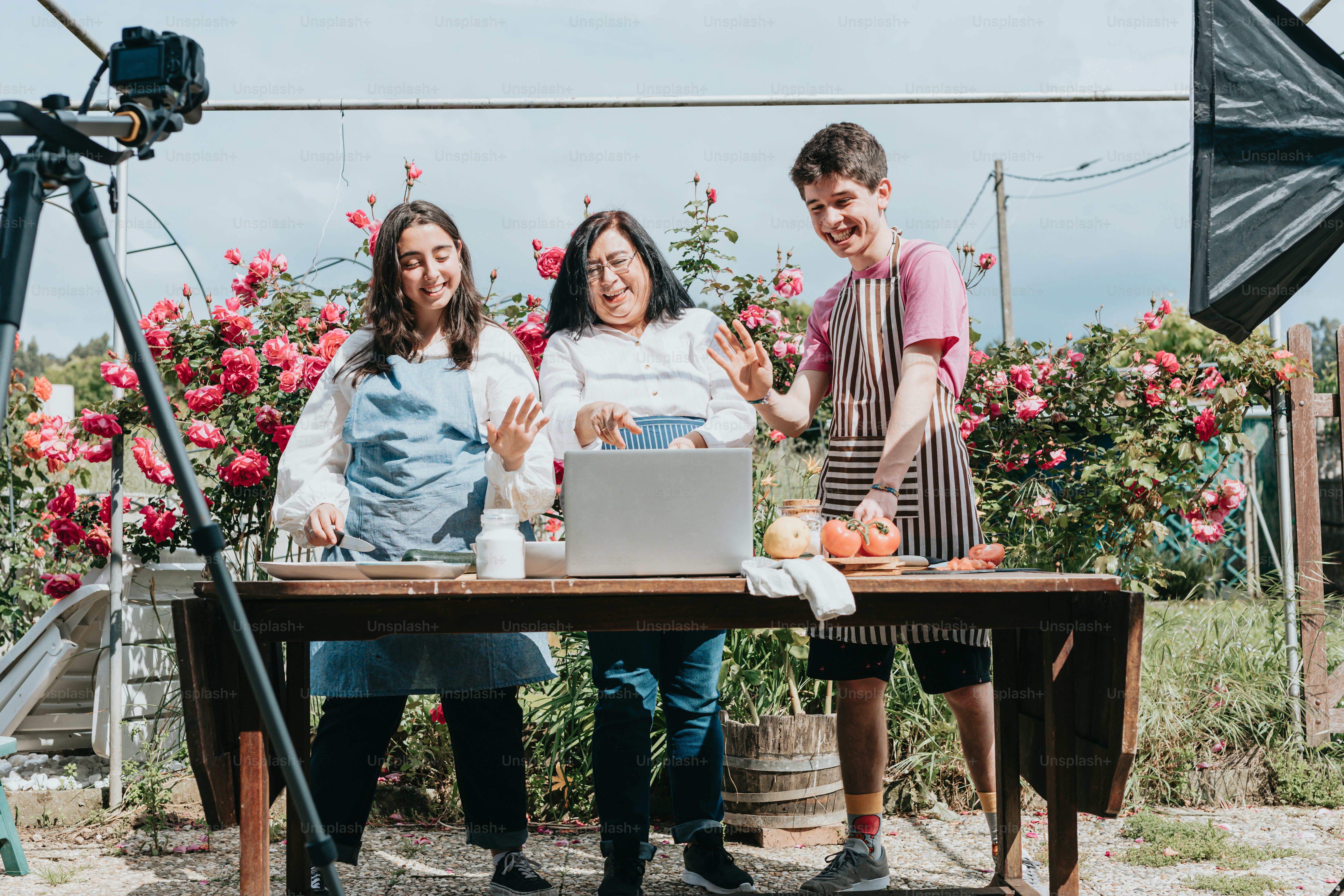 a group of people standing around a table with a laptop