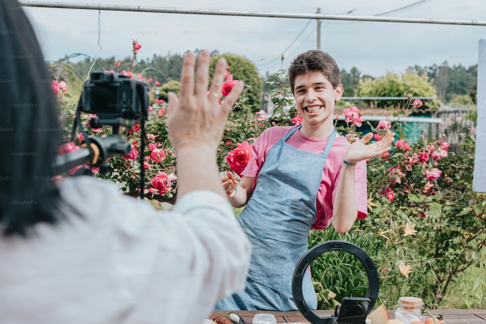 a woman taking a picture of a man in a garden