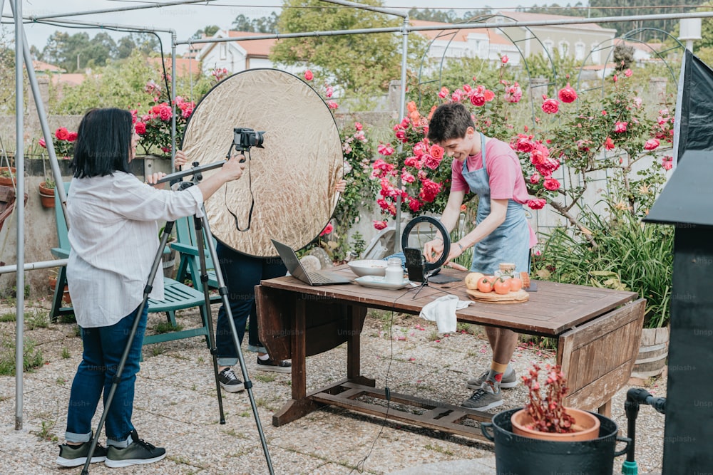 a woman is filming another woman in a garden
