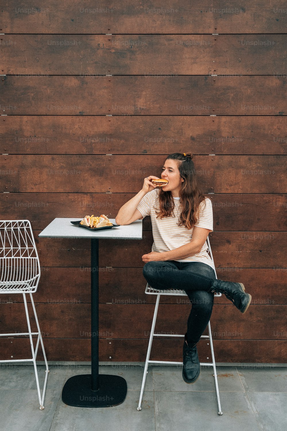 une femme assise à une table en train de manger de la nourriture