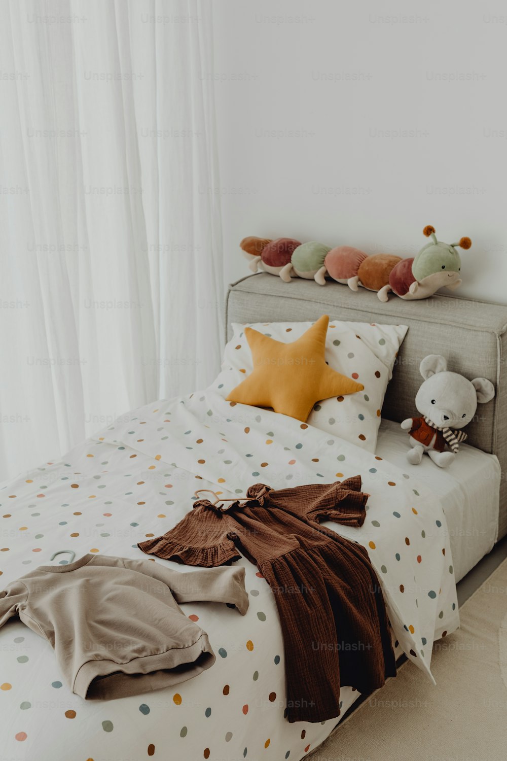 a bed with a polka dot comforter and pillows