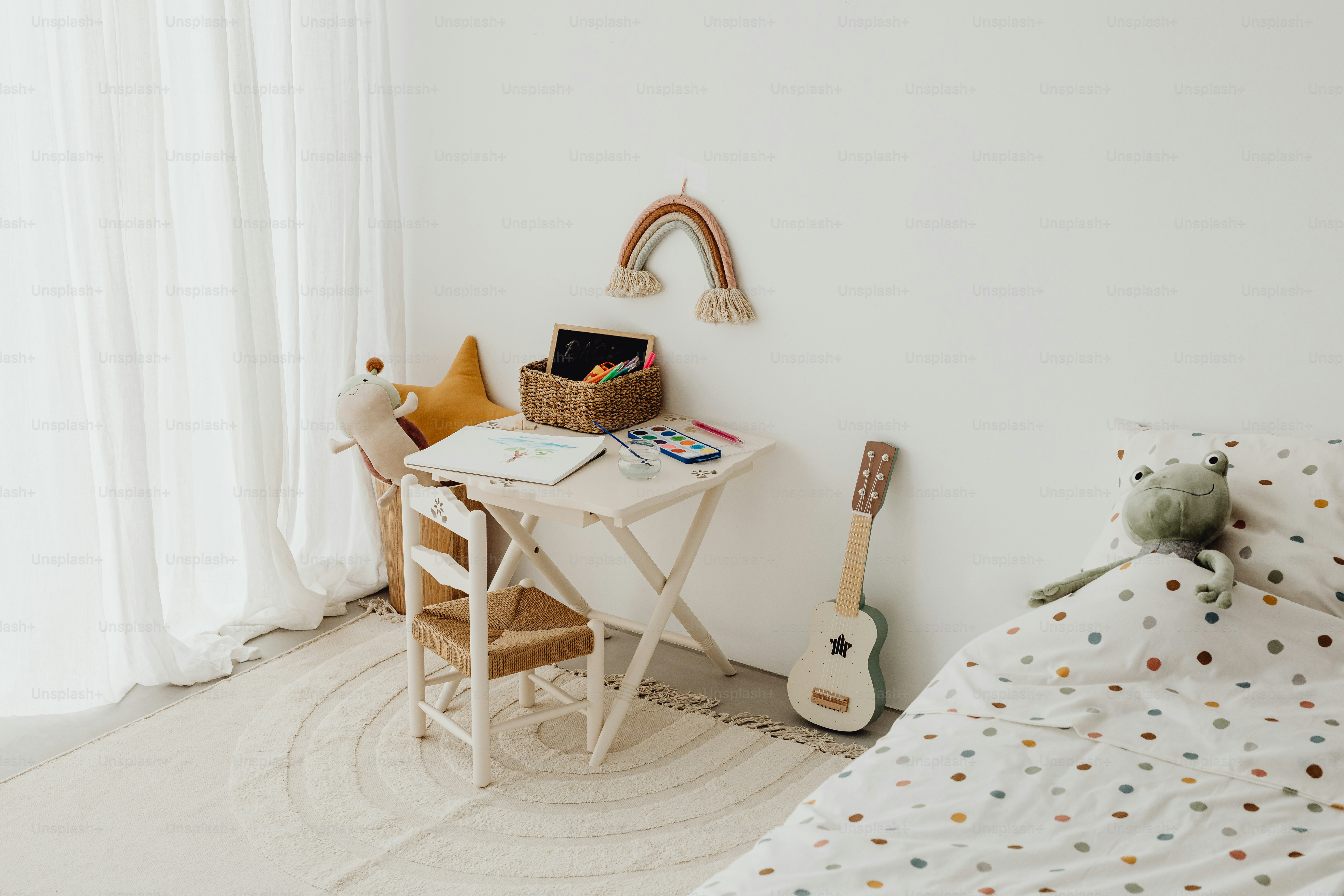 a child's room with a bed, desk, and guitar