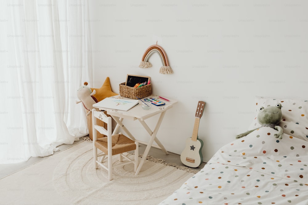 a child's room with a bed, desk, and guitar