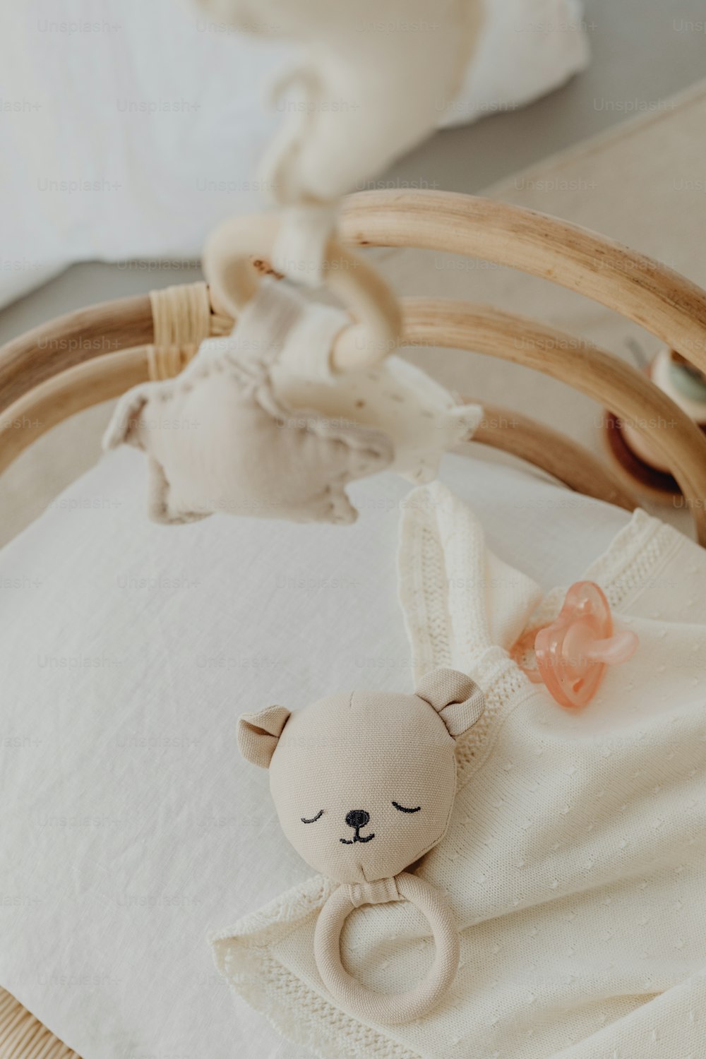 a baby crib with a stuffed animal hanging from it's side