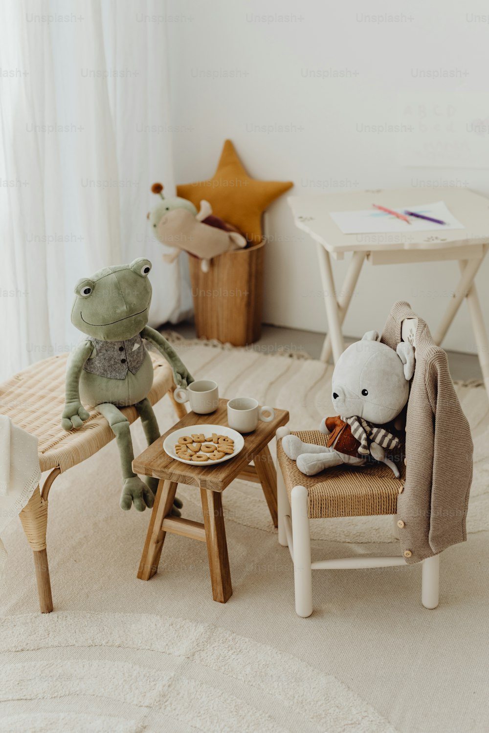two stuffed animals sitting on chairs in a room