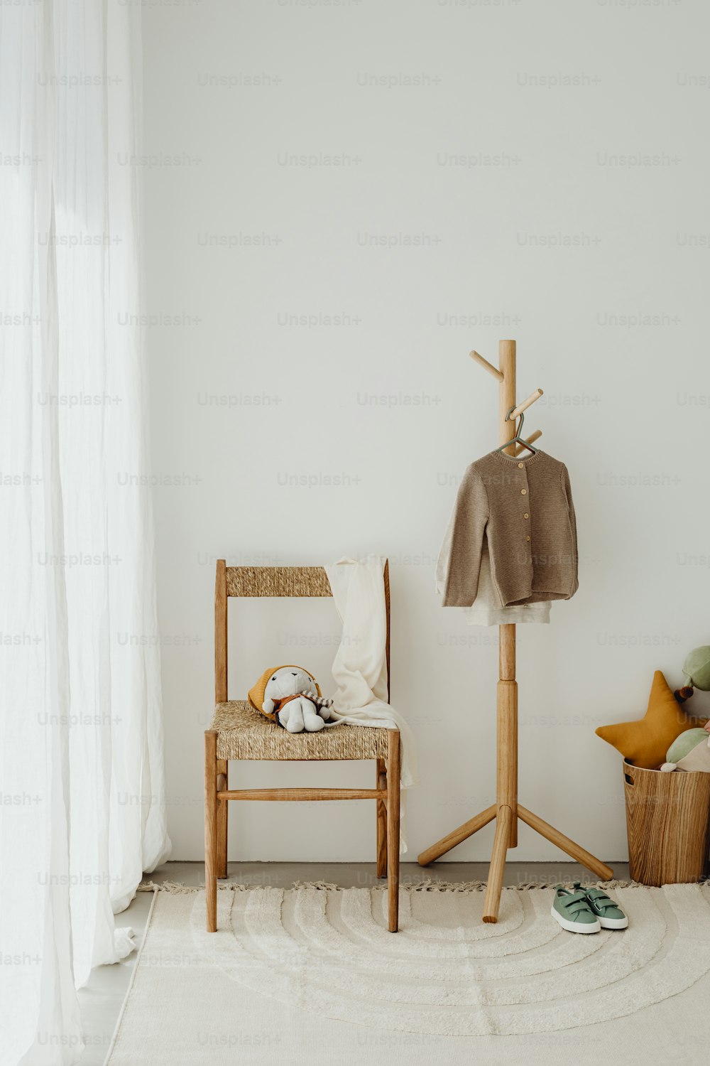 a white room with a chair and a coat rack