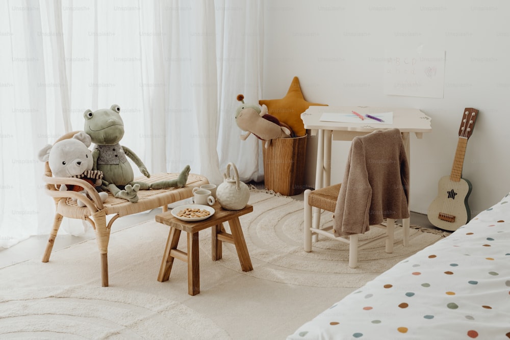a room with a bed, table, and stuffed animals