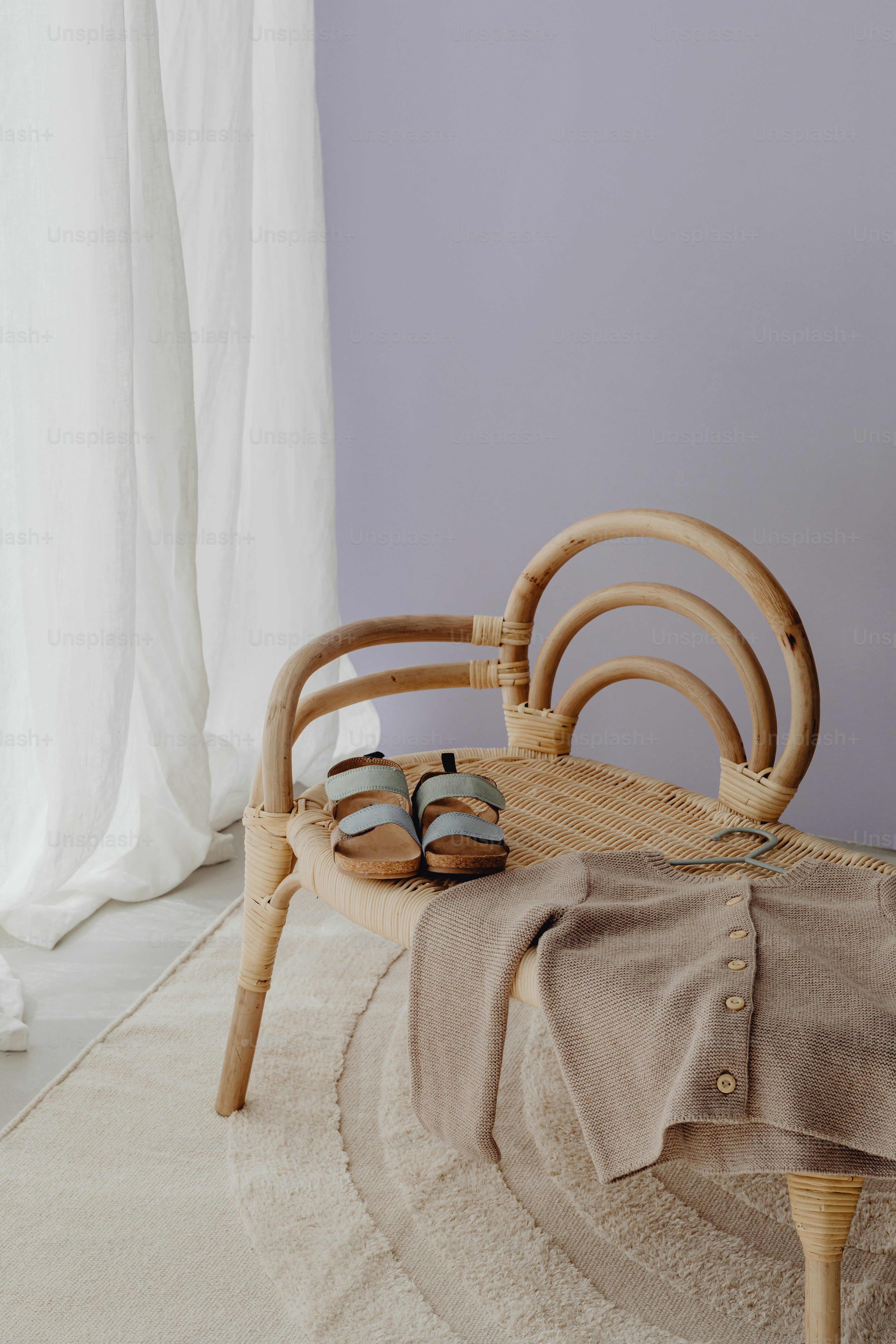 a pair of sandals sitting on top of a bed