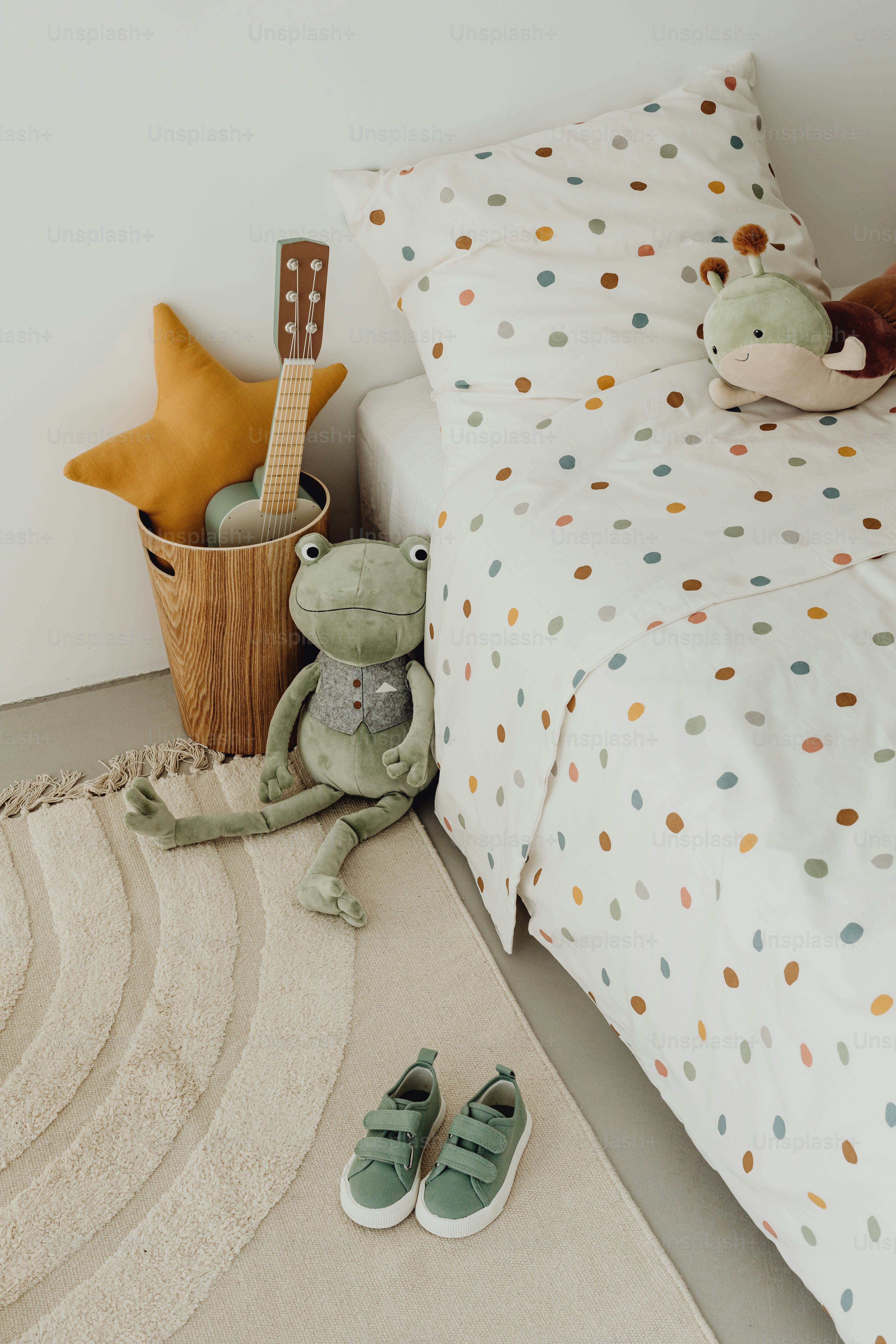 a bedroom with a bed and a stuffed animal on the floor