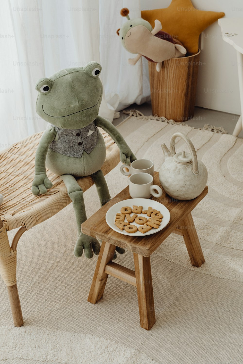 a frog sitting on a chair next to a plate of food