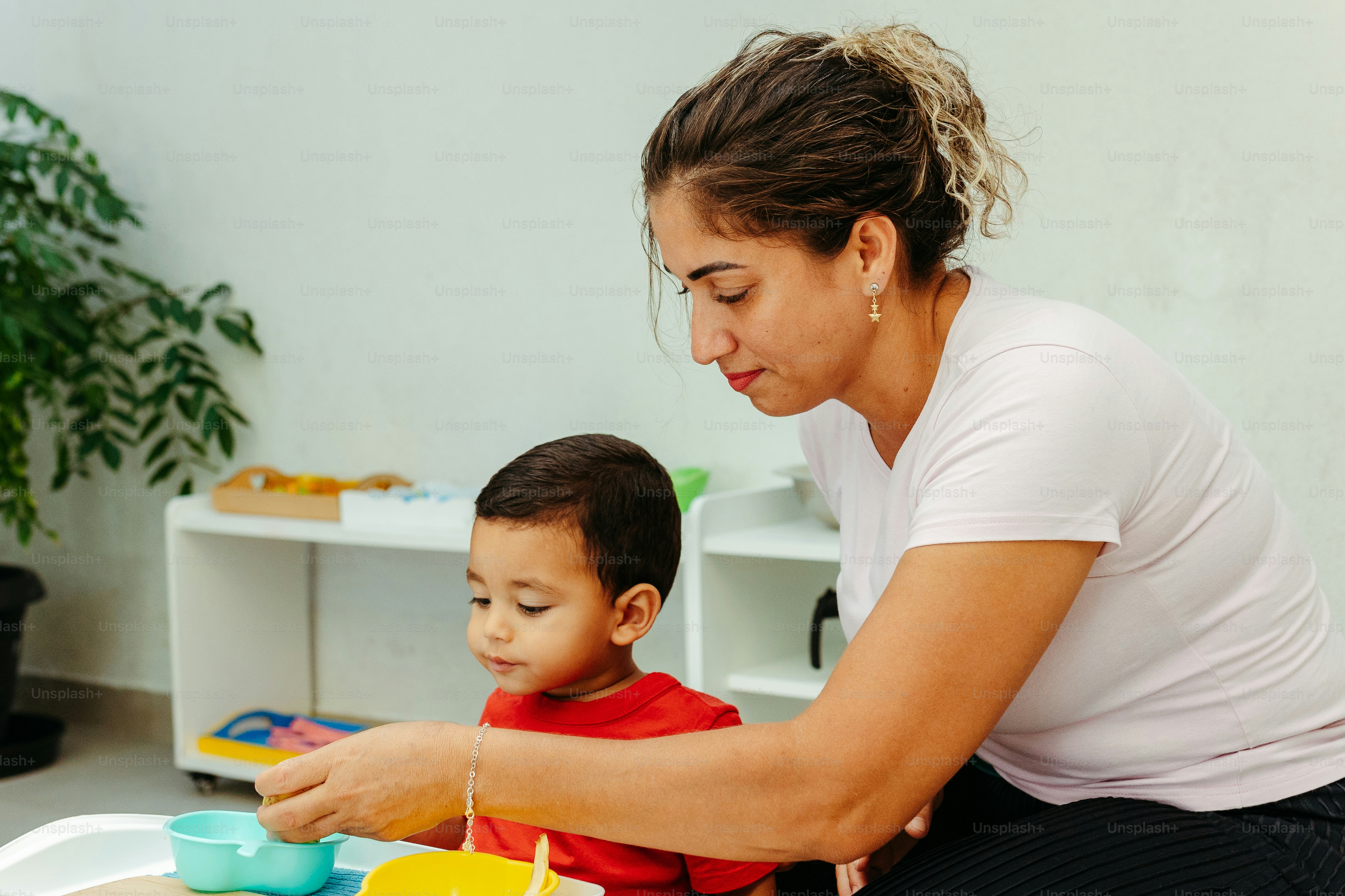 a woman sitting next to a child in a room
