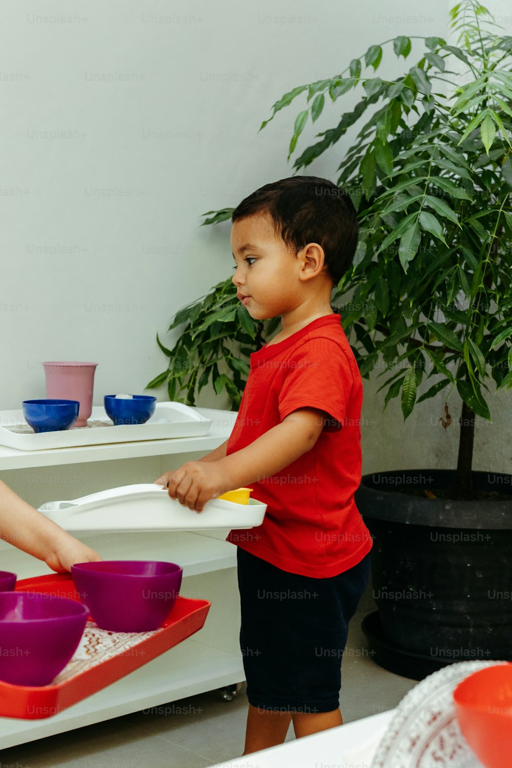 a boy and a girl are playing with bowls