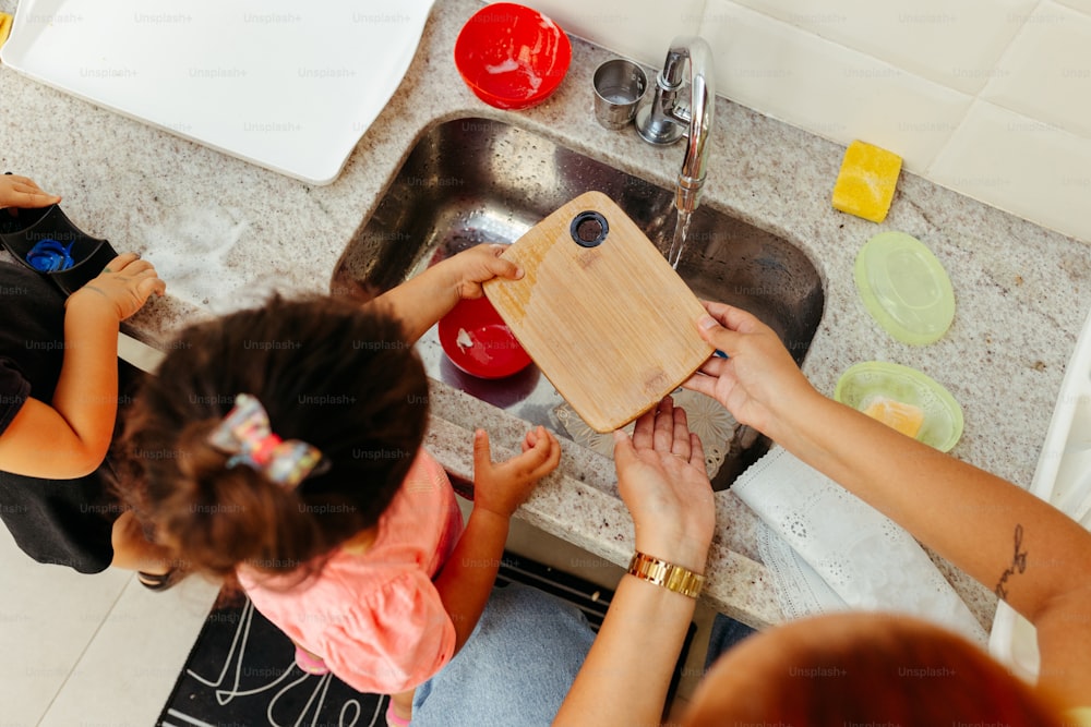 a woman and a little girl standing in a kitchen