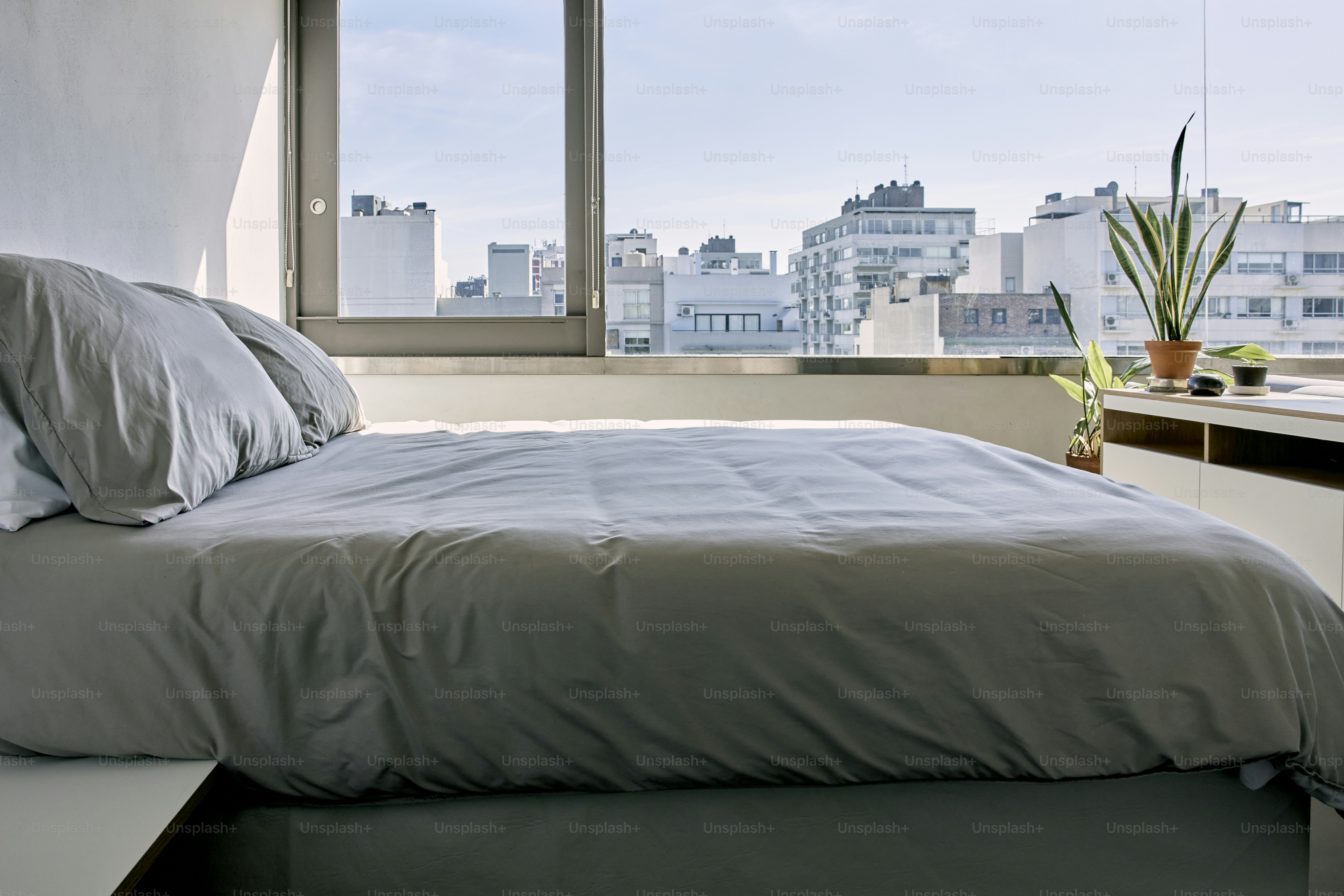 un letto seduto in una camera da letto accanto a una finestra