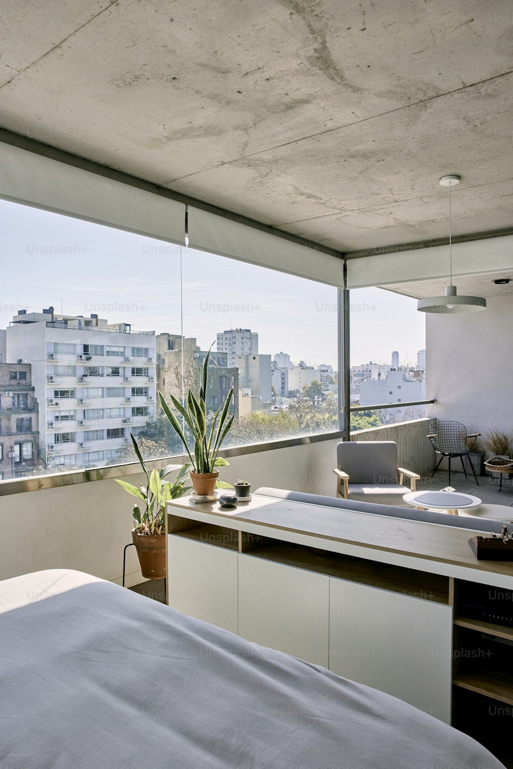 a bedroom with a view of the city