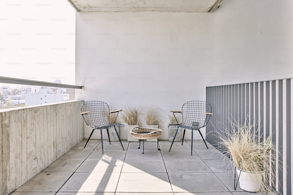 a couple of chairs sitting on top of a cement floor