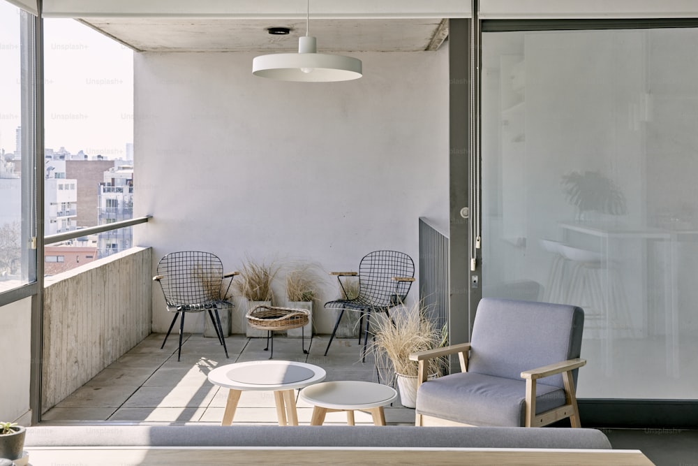 a balcony with chairs and a table on it