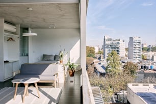 a balcony with a couch and a table on it