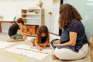 a group of children sitting on the floor working on a project