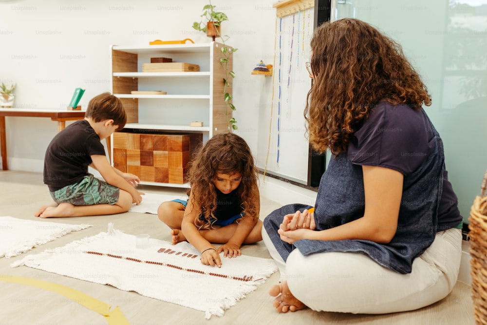 a group of children sitting on the floor working on a project