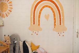 a child's room with a rainbow painted on the wall