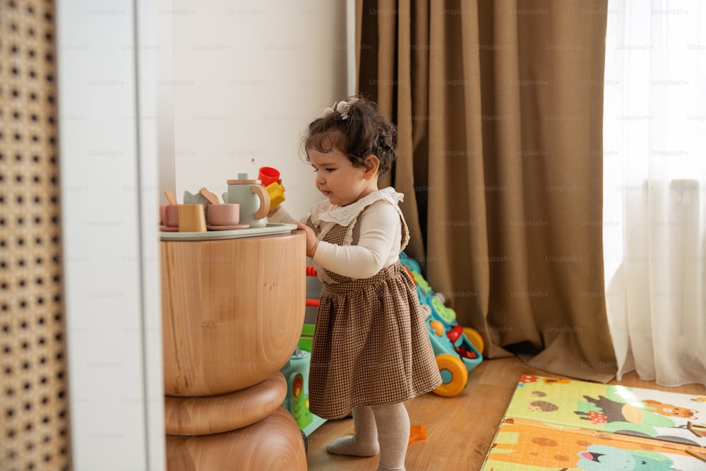 a little girl playing with toys in a room