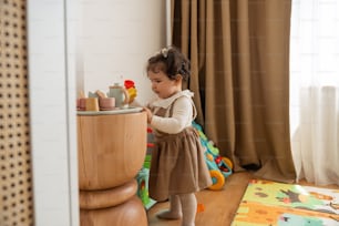a little girl playing with toys in a room